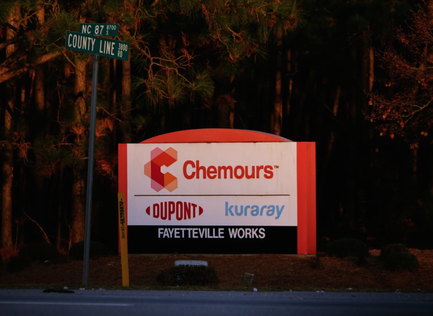 Logo signs of Dupont, Chemours, and Kuraray off the road